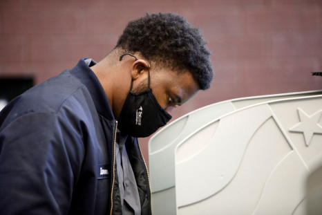 A voter marks his ballot at a polling station during the 2020 presidential election in Durham, Durham County, North Carolina, U.S., November 3, 2020.   