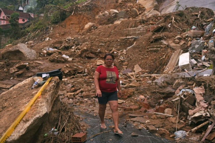 A woman walks through the wreckage of a giant landslide in Petropolis, Brazil, on February 19, 2022