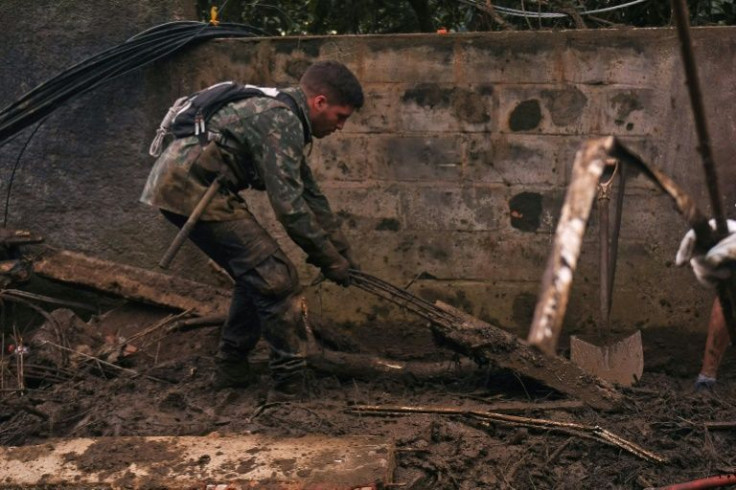 A volunteer participates in a rescue mission on on February 19, 2022 after a giant landslide in the Caxambu neighborhood in Petropolis, Brazil