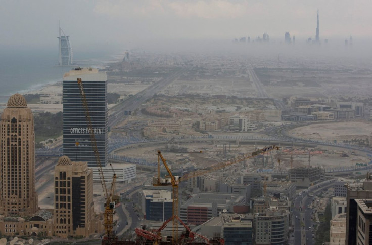 An early evening view of the Burj Dubai (top right) and Burj Al Arab (back left) with construction work in the foreground, late November 15, 2008.