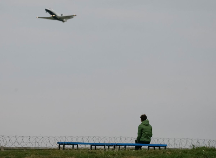 A woman looks on as a business jet airplane takes off in Kyiv, Ukraine September 17, 2021.