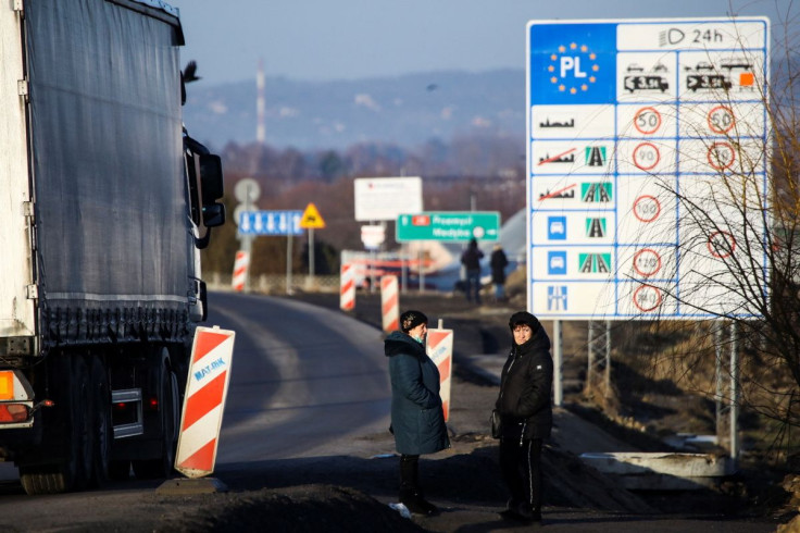 People stand at the border crossing between Poland and Ukraine, after Russian President Vladimir Putin authorized a military operation in eastern Ukraine, in Medyka, Poland, February 24, 2022.