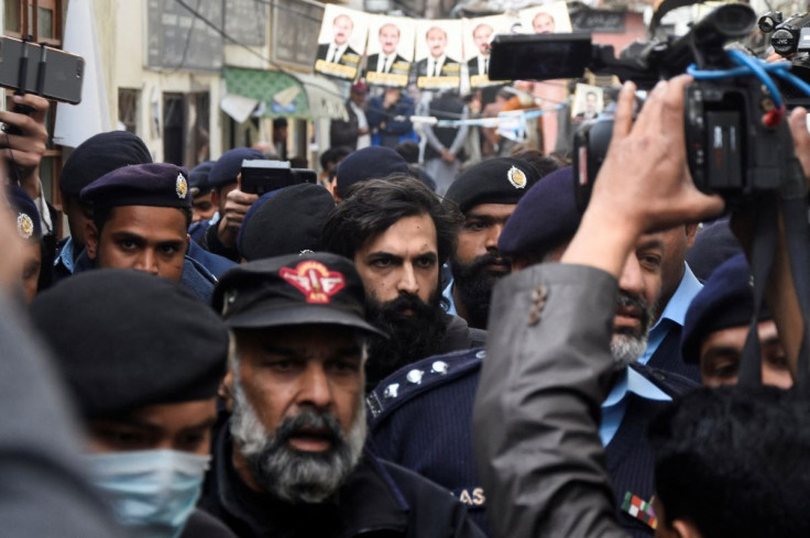 Police officers escort Zahir Jaffer, a U.S. national of Pakistani origin, after court announced a death sentance to him for raping and beheading Noor Mukadam, 27, the daughter of a former diplomat, at district court in Islamabad, Pakistan February 24, 202