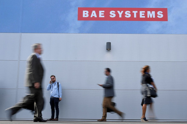 Trade visitors walk past an advertisement for BAE Systems at Farnborough International Airshow in Farnborough, Britain, July 17, 2018.