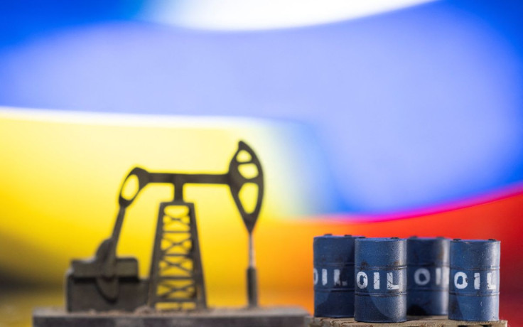 Models of oil barrels and a pump jack are displayed in front of Ukrainian and Russian flag colors in this illustration taken, February 24, 2022. 