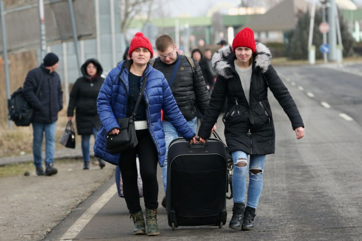 People flee from Ukraine at the Hungarian-Ukrainian border after Russian President Vladimir Putin authorized a military operation, in Beregsurany, Hungary, February 24, 2022. 