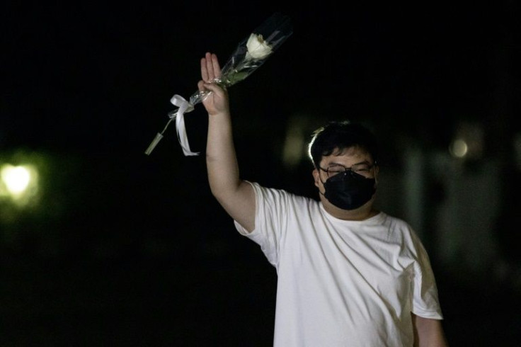 As he walked free, wearing a white T-shirt and holding a white rose, Parit gave the three-fingered salute adopted as a gesture of defiance by the protest movement from the "Hunger Games" movies