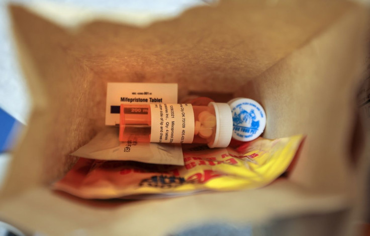 Paper bags containing the medication used for a medical abortion, follow-up instructions, and heating pads are prepared for patients who will be having abortions that day at Trust Women clinic in Oklahoma City, U.S., December 6, 2021. 