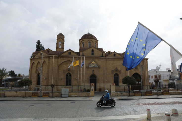 A man rides his motorcycle in front of the church of St. George in the Ayios Dhometios suburb of Nicosia, Cyprus February 24, 2022.
