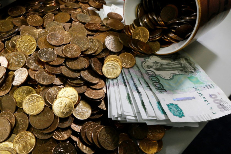 Russian 1000-rouble banknotes, 50 and 10 kopeck coins are seen on a table at a private company's office in Krasnoyarsk, Siberia November 6, 2014.