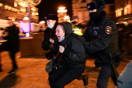 Police in Moscow detain a protestor against Russia's invasion of Ukraine