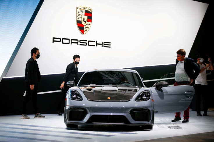 Attendees look at the 2022 Porsche 718 Cayman GT4 RS during the 2021 LA Auto Show in Los Angeles, California, U.S. November 17, 2021. 