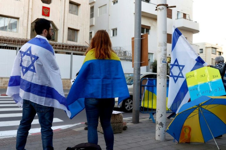 People clad in the Israeli and Ukranian flags take part in a Tel Aviv protest against Russia's attack on Ukraine