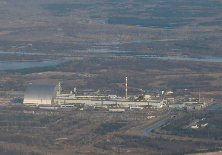 An aerial view from a plane shows a New Safe Confinement (NSC) structure over the old sarcophagus covering the damaged fourth reactor at the Chernobyl Nuclear Power Plant during a tour to the Chernobyl exclusion zone, Ukraine April 3, 2021. 