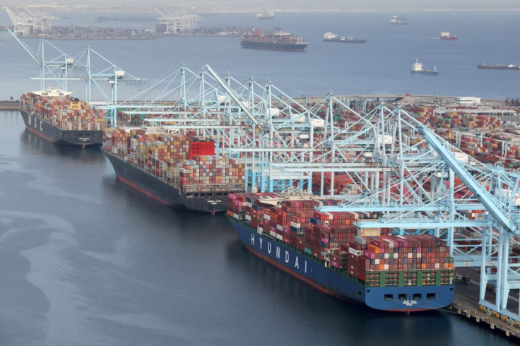 Shipping containers are unloaded from ships at a container terminal at the Port of Long Beach-Port of Los Angeles complex in Los Angeles, California, U.S., April 7, 2021.