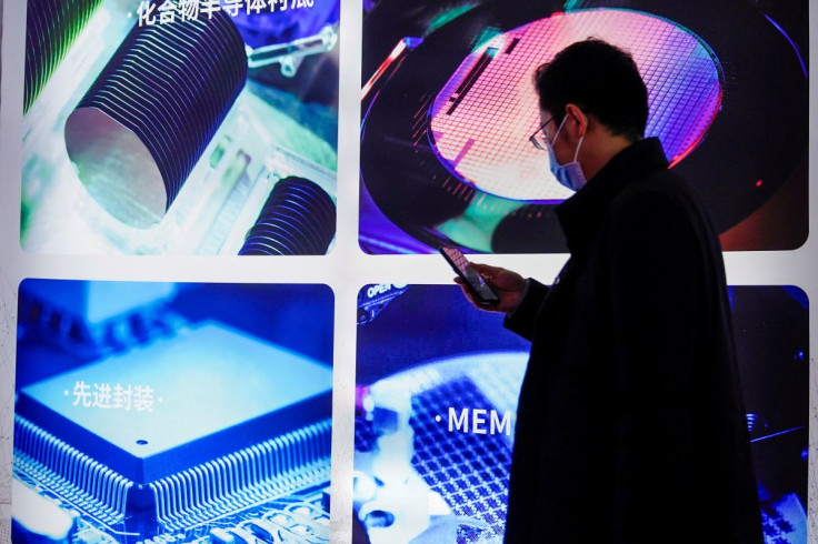 A man visits a display of semiconductor devices at Semicon China, a trade fair for semiconductor technology, in Shanghai, China March 17, 2021.