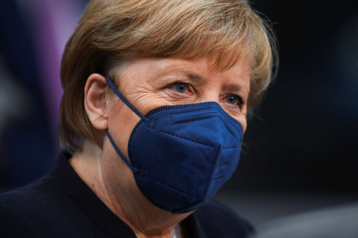 Germany's outgoing Chancellor Angela Merkel wearing a protective mask attends a session of the German lower house of parliament Bundestag to elect a new chancellor, in Berlin, Germany, December 8, 2021.