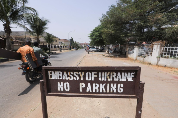 People on a motorbike drive past the Ukrainian embassy in Abuja, Nigeria February 25, 2022.