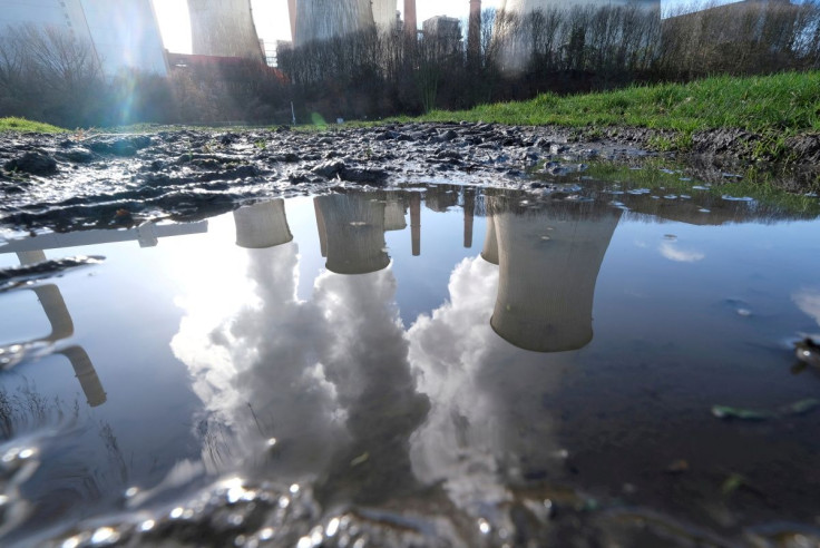 The lignite (brown coal) power plant complex of German energy supplier and utility RWE is reflected in a large puddle in Neurath, northwest of Cologne, Germany, February 5, 2020.