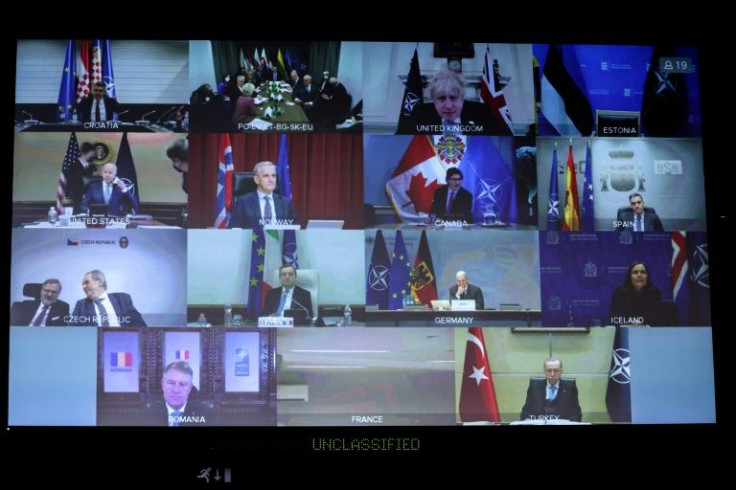 NATO leaders are seen on a huge screen as they attend a video summit on the Russian invasion of the Ukraine at the NATO headquarters in Brussels