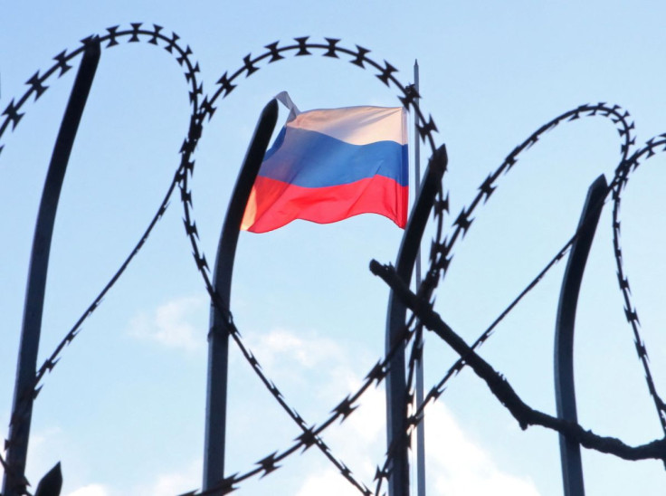 The Russian flag is seen behind a razor wire fence on the roof of the Russian Consulate General in Kharkiv, Ukraine February 23, 2022. 