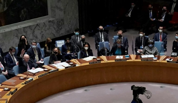 Permanent Representative of the Russian Federation to the United Nations, Vassily Nebenzia (C) holds his hand up during a vote on a draft resolution that would condemn Russia for invading Ukraine in New York, February 25, 2022
