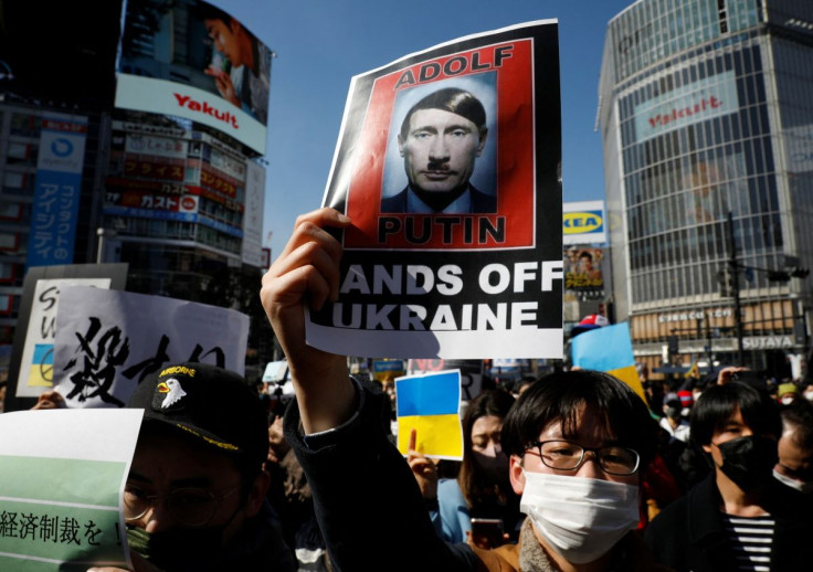 Protesters hold banners during a rally against Russia's invasion of Ukraine, in Tokyo, Japan, February 26, 2022.