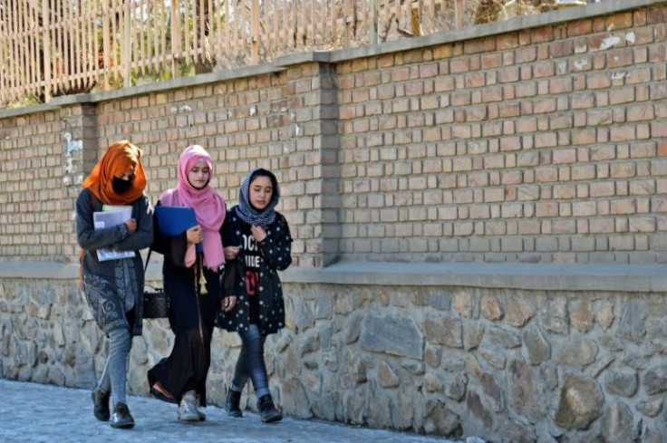Students walk towards Kabul University after it was reopened in Kabul in Kabul six months after the Taliban's return to power