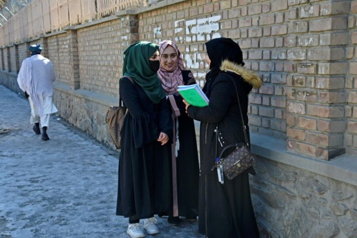 Female students chat near Kabul University after classes ended whenb the institution reopened its doors