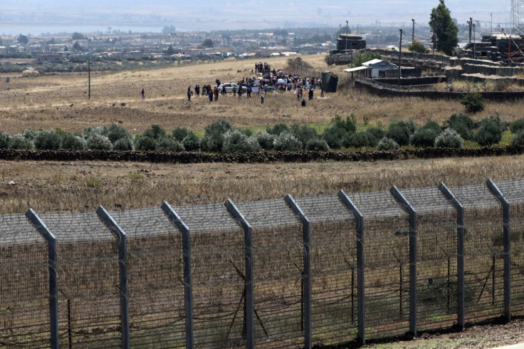 Internally displaced refugees across the Golan Heights protest near the border between Israel and Syria in an appeal to the United Nations and the international community to stop Russia from carrying out an offensive, as it is seen from the Israeli-occupi