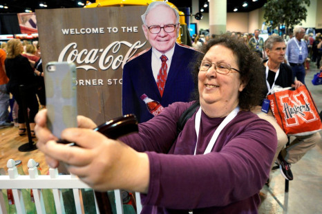 A shareholder takes a selfie with a picture of Warren Buffett at the Berkshire Hathaway Inc annual meeting, the largest in corporate America, in its hometown of Omaha, Nebraska, U.S., May 4, 2018. 