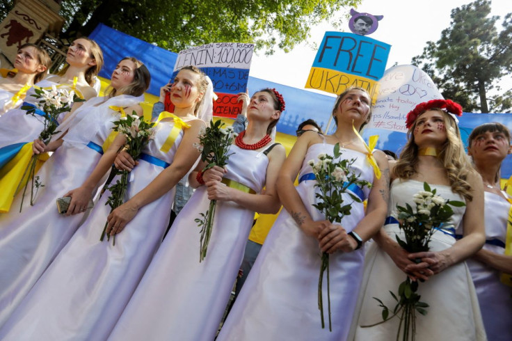 Ukrainian women dressed as brides hold a protest outside the Russian Embassy, after Russia launched a massive military operation against Ukraine, in Mexico City, Mexico February 26, 2022. 