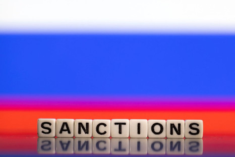 Plastic letters arranged to read "Sanctions" are placed in front of Russian flag colors in this illustration taken February 25, 2022. 