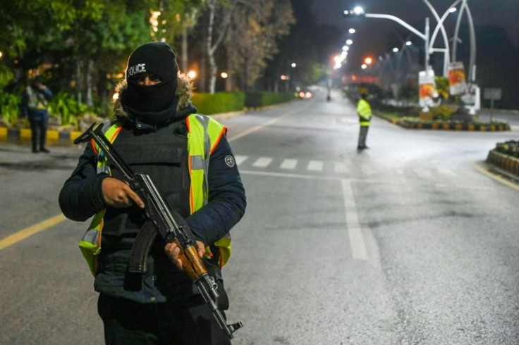Policemen guard a street for the arrival of Australian cricketer team members in Islamabad on February 27, 2022, on their first tour of the country in nearly a quarter of a century.