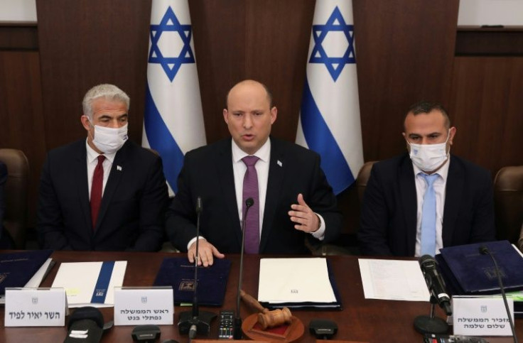 Israeli Prime Minister Naftali Bennett, in the centre, Foreign Minister Yair Lapid, on the left, and Government Secretary Shalom Shlomo attend a cabinet meeting in Jerusalem on February 27, 2022