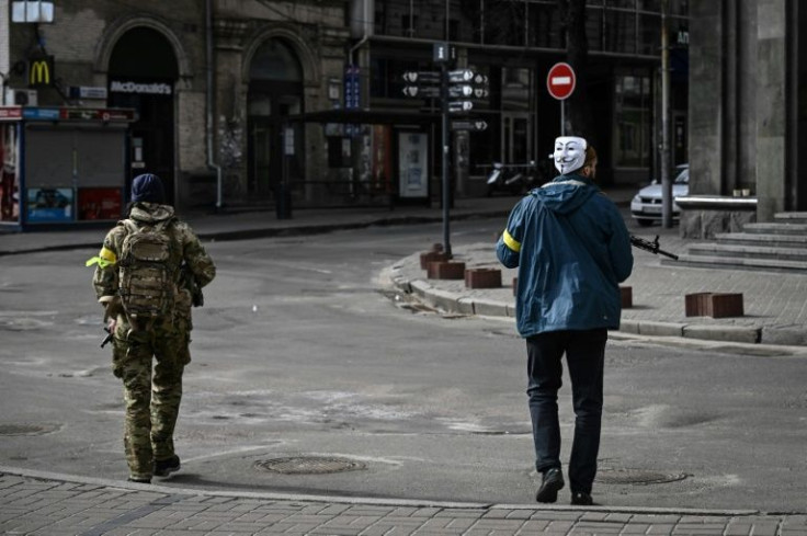 One Ukrainian territorial defence soldier patrolled the streets wearing a Guy Hawks mask