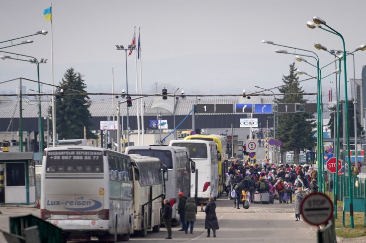 People fleeing the Russian invasion in Ukraine stand in line at the border crossing for entry into Poland, in Shehyni, Ukraine, February 27, 2022.