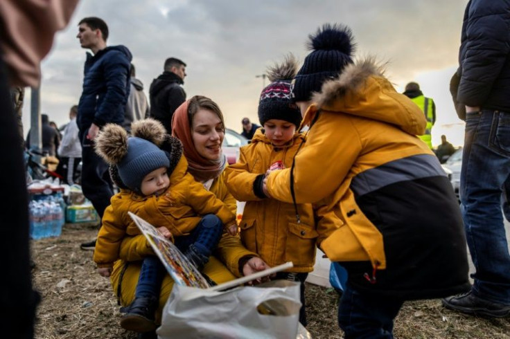Women and children waiting for hours in the cold to cross into Poland, where they were helped by volunteers