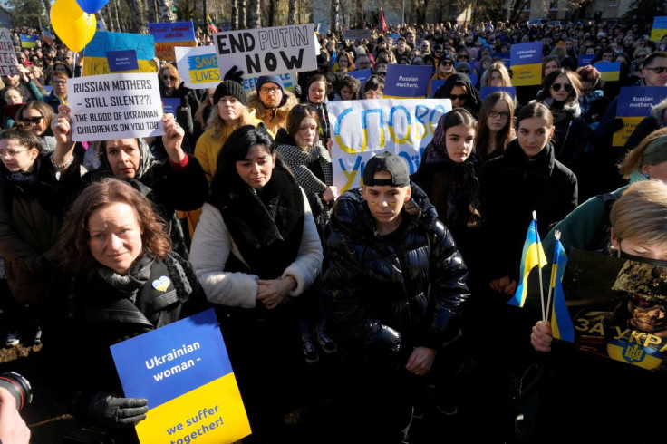 A woman holds a placard during women's protest march in front of the Russian embassy in Vilnius, Lithuania February 27, 2022.