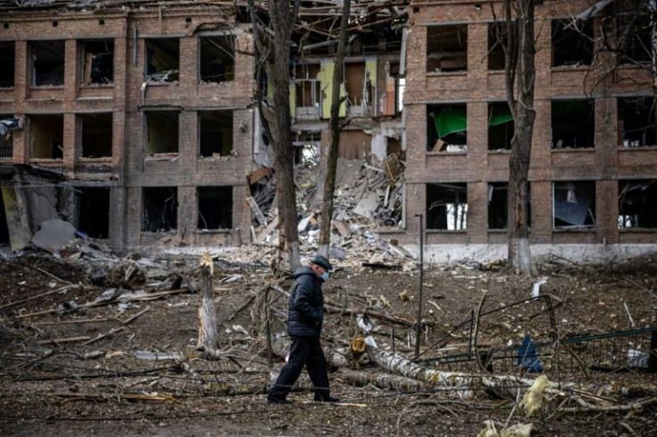 A man walks in front of a destroyed building after a Russian missile attack in the Ukrainian town of  Vasylkiv, near Kyiv.