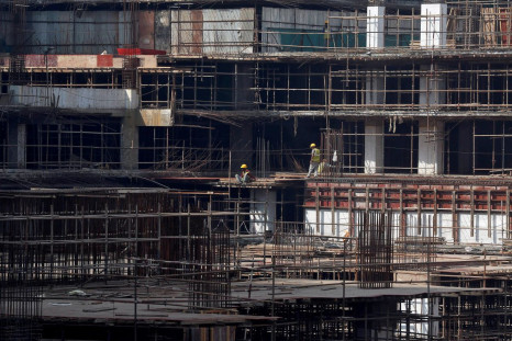 Construction workers work on a site of a residential building in Mumbai, India, November 30, 2016. 