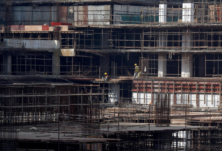 Construction workers work on a site of a residential building in Mumbai, India, November 30, 2016. 