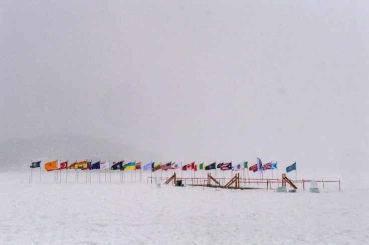 Flags representing countries from around the world line the 75-foot pool cut into Lake Memphremagog, where swimmers from around the US and Canada compete at the Memphremagog Winter Swimming Festival in Newport, Vermont on February 25, 2022
