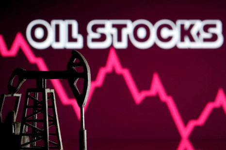 A 3D printed oil pump jack is seen in front of displayed stock graph and "Oil Stocks" words in this illustration picture, April 14, 2020. 