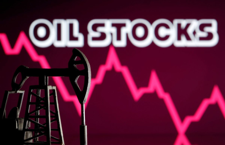 A 3D printed oil pump jack is seen in front of displayed stock graph and "Oil Stocks" words in this illustration picture, April 14, 2020. 