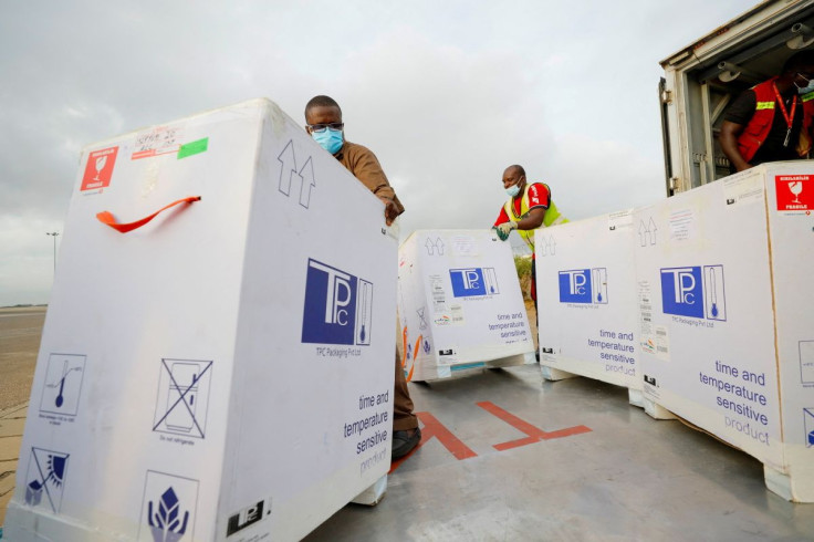 Workers load a truck with 350,000 doses of Oxford/AstraZeneca coronavirus disease (COVID-19) vaccines, redeployed from the Democratic Republic of Congo, at the Kotoka International Airport in Accra, Ghana, May 7, 2021.