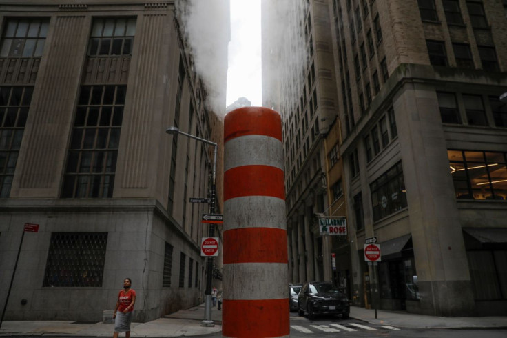 A person walks by a steam pipe in the Financial District after The United Nations released the Intergovernmental Panel on Climate Change's (IPCC) latest report, in Manhattan, New York City, U.S., August 9, 2021.