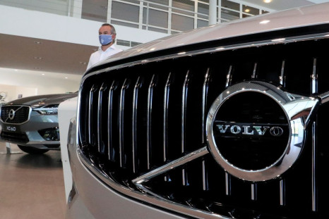 An employee at a Volvo car dealer, wearing a protective mask is seen in a showroom, in Brussels, Belgium, May 28, 2020. 