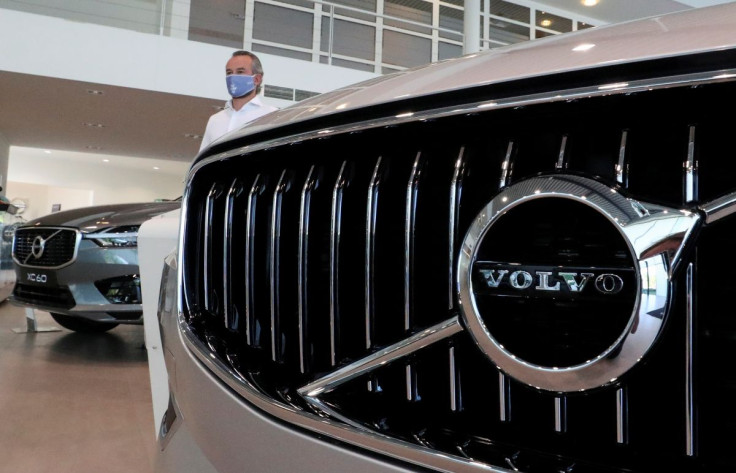 An employee at a Volvo car dealer, wearing a protective mask is seen in a showroom, in Brussels, Belgium, May 28, 2020. 