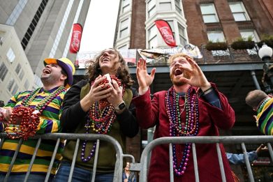 Spectators reach to catch Mardi Gras beads during Carnival celebrations in advance of Mardi Gras, in New Orleans, Louisiana, U.S., February 27, 2022. Picture taken February 27, 2022. 